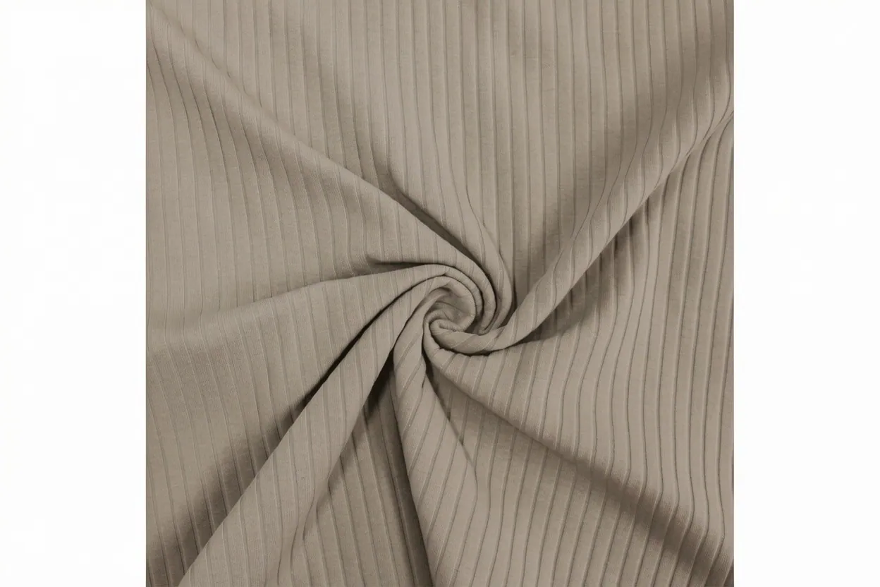 Rib-jersey blend knit fabric in warm grey cotton with combined rib and smooth zones, manufactured at Apex Corporation knitwear factory in Karachi Pakistan